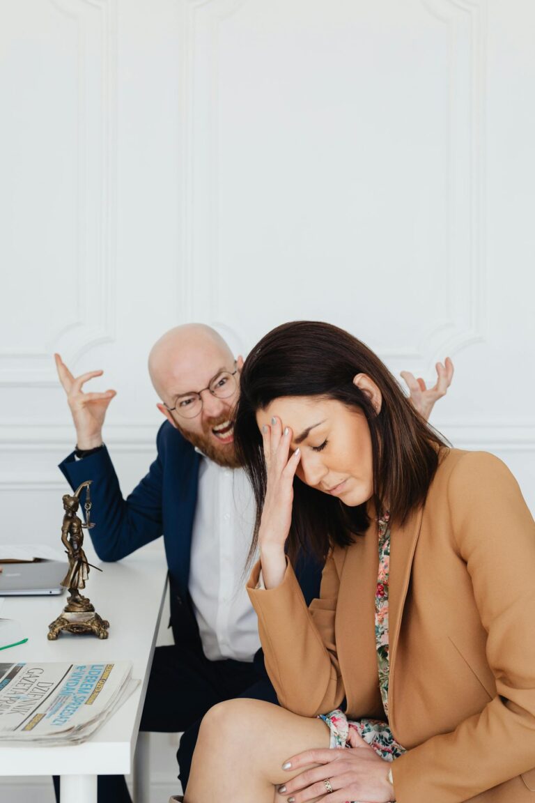 Two colleagues in a law office engaging in a tense discussion, showcasing frustration and stress.